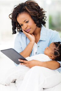 serious african mother using tablet computer