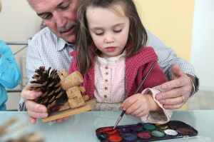 Granddaughter and grandfather painting