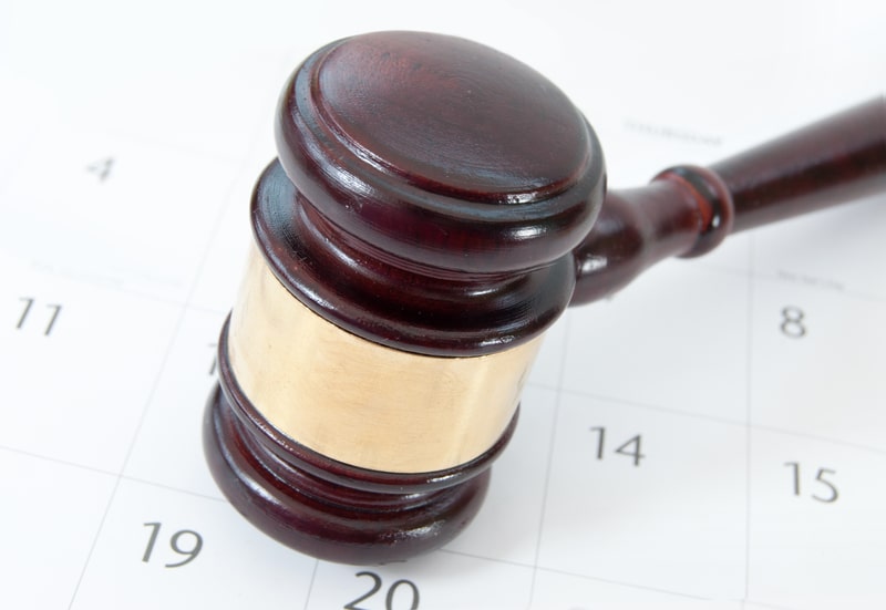 A gavel on a calendar